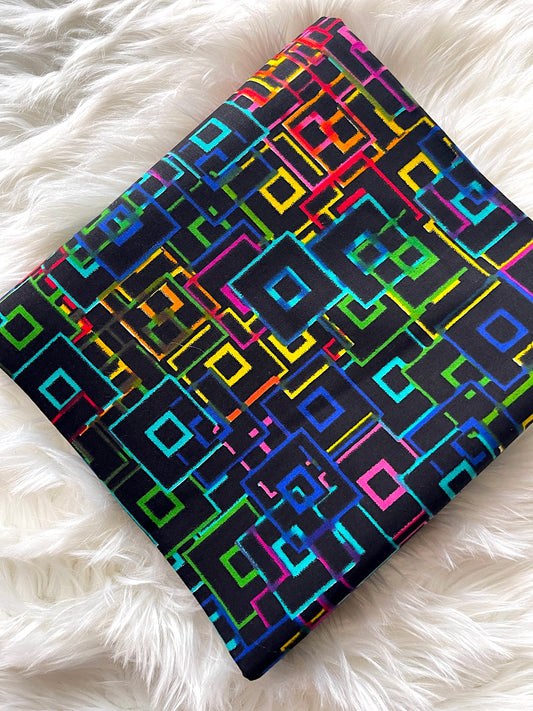Colorful geometric patterned notebook on a white fluffy surface