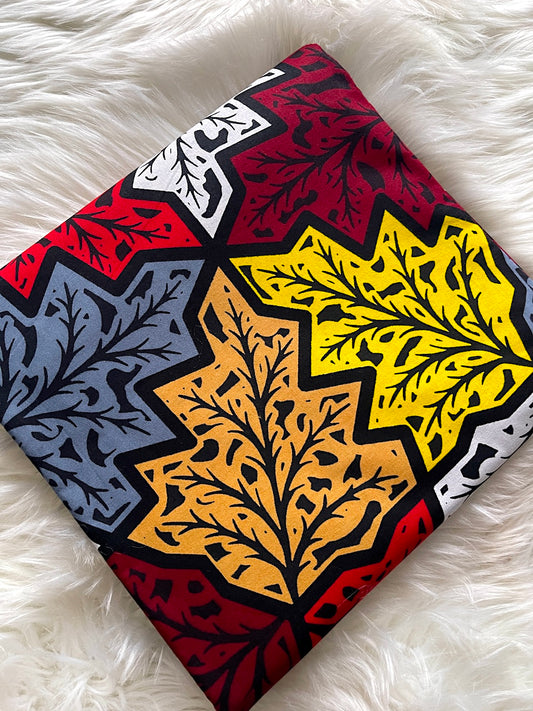 Colorful patterned fabric with star designs on a white fluffy surface