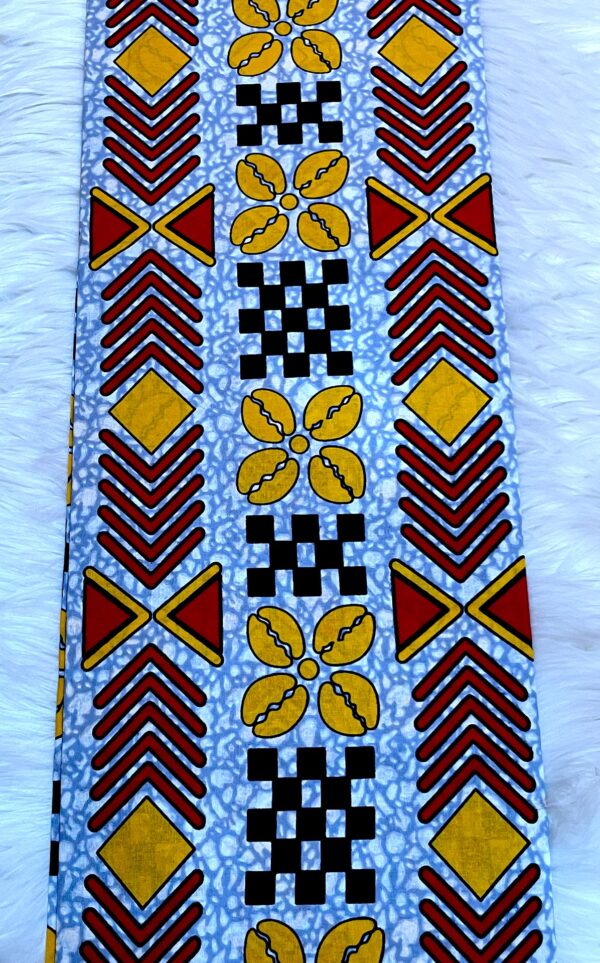 Patterned fabric with red, yellow, and black designs on a blue background