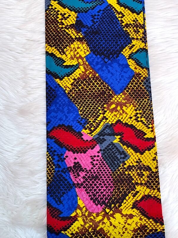 Colorful patterned fabric with a snake-like design on a white background