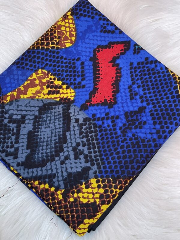 Colorful patterned fabric with blue, yellow, and red colors on a white background