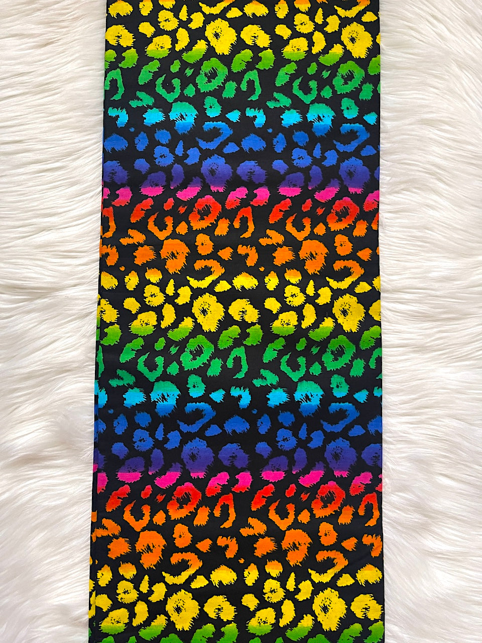 Colorful leopard print pattern on a black background