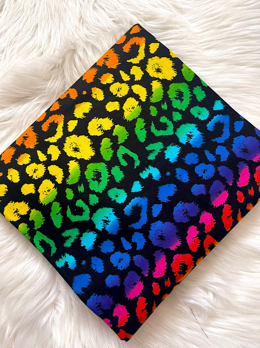 Colorful leopard print fabric on a white fluffy surface