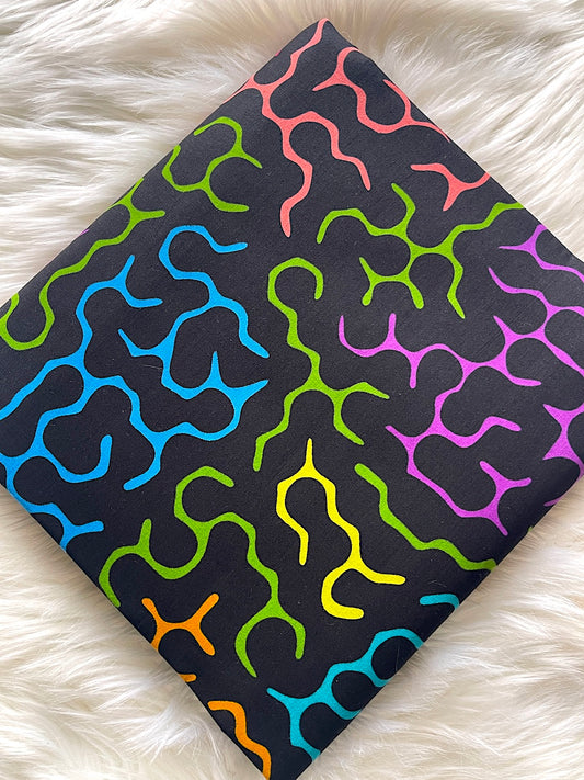 Colorful patterned fabric on a white fluffy surface