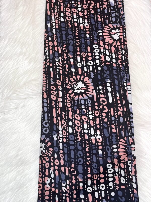 Patterned fabric with pink and blue design on a white background