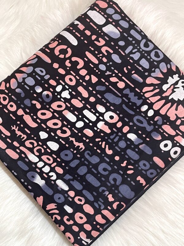 Patterned notebook with pink, purple, and white design on a light background