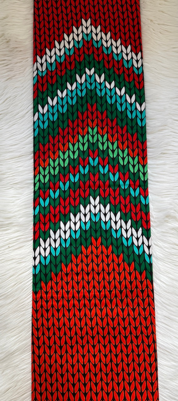 Knitted tie with a colorful zigzag pattern on a white background