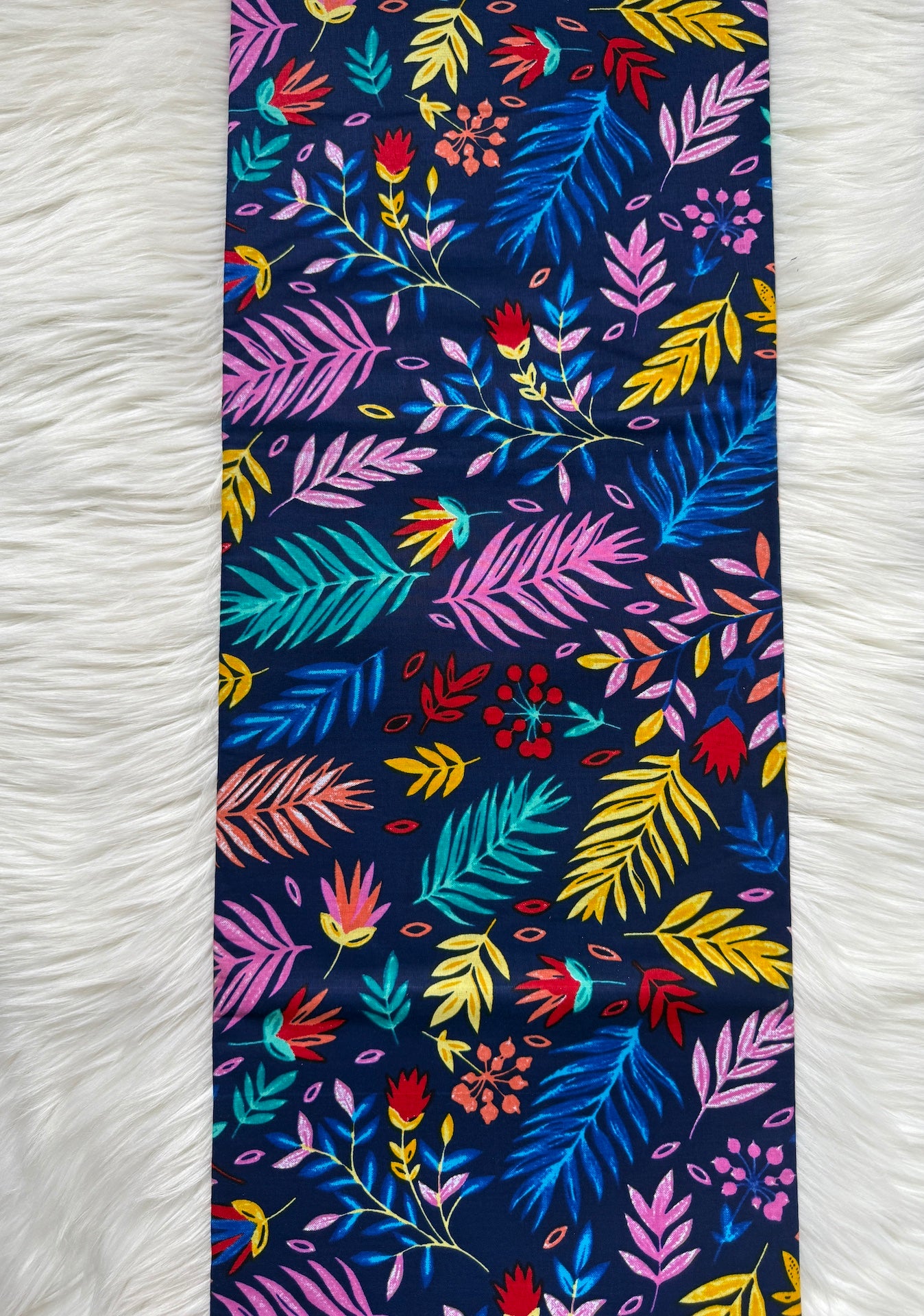 Colorful floral patterned fabric on a white textured background