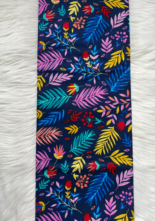 Colorful floral patterned fabric on a white textured background