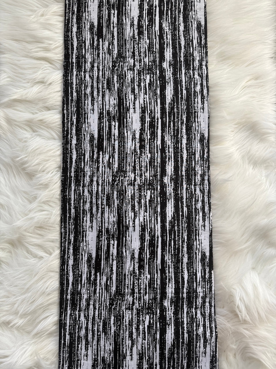 Black and white striped fabric on a fluffy white background