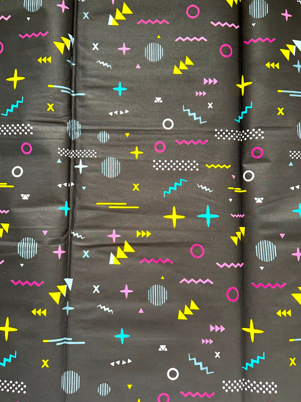Dark fabric with colorful geometric pattern