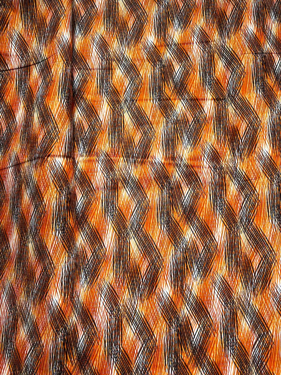 Close-up of woven pattern with orange and black colors