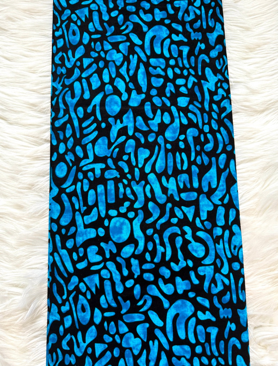 Blue patterned fabric on a white textured background