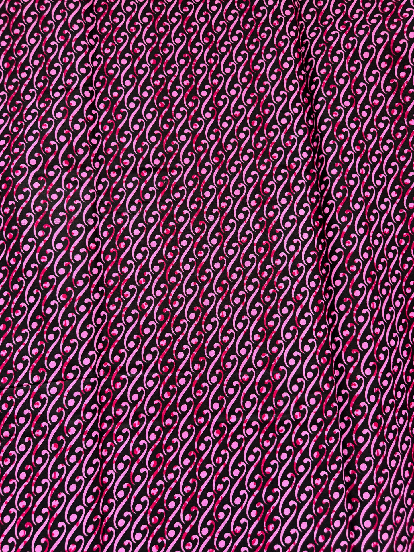 Close-up of a textured pink fabric with a chain-like pattern