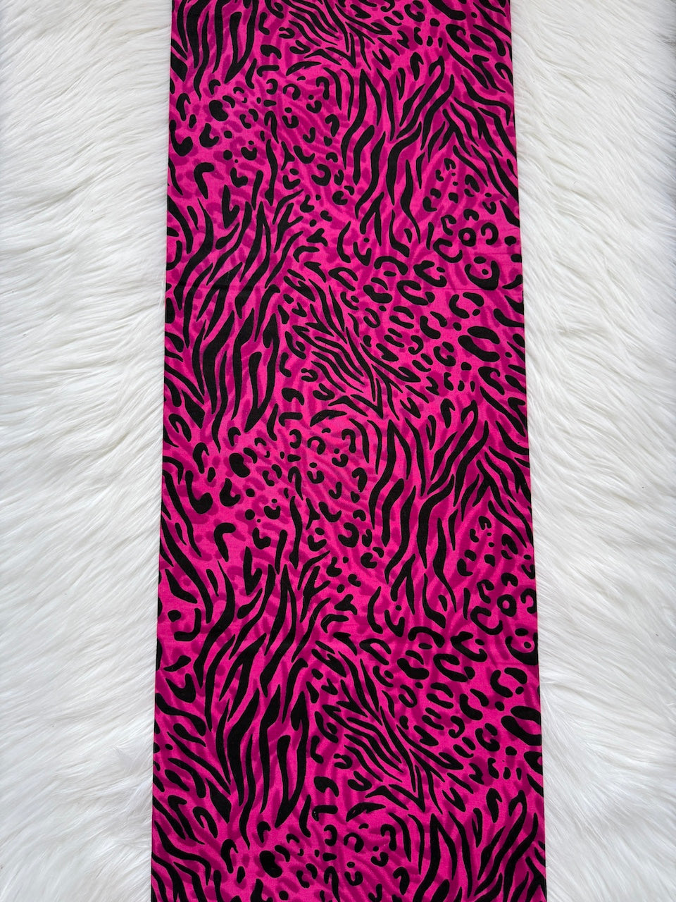 Pink and black zebra print fabric on a white background