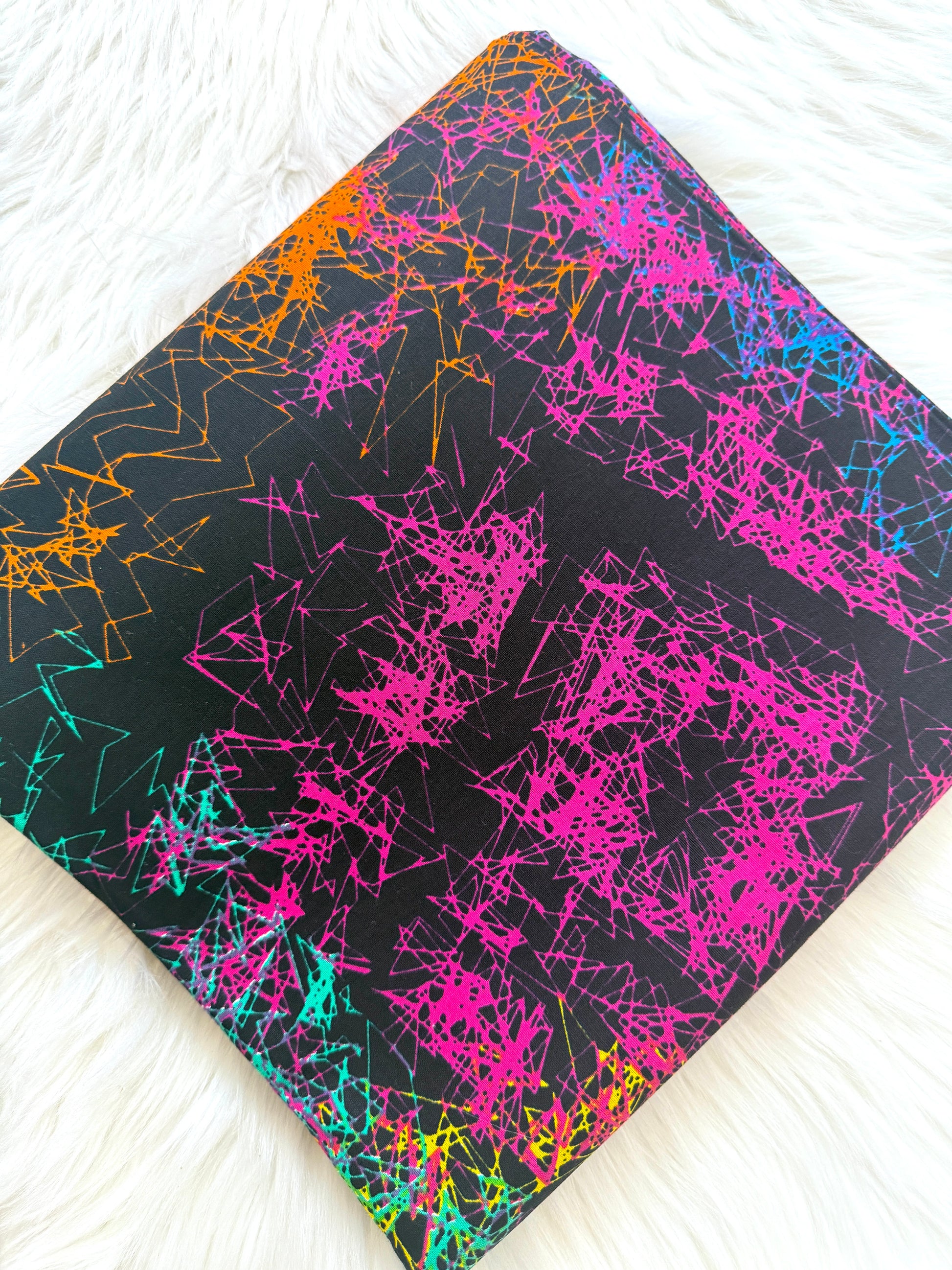Colorful splatter pattern on a black background