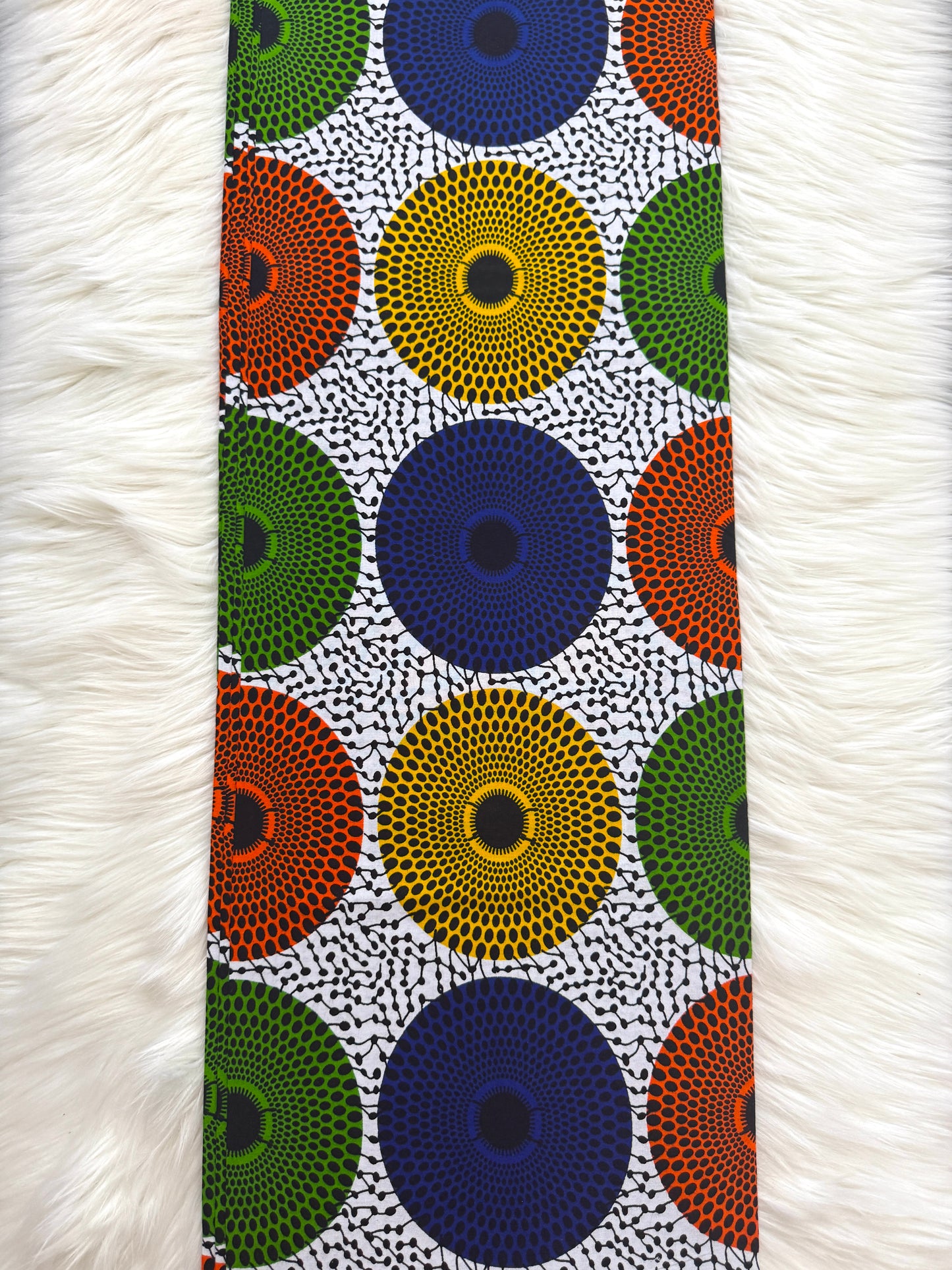 Patterned fabric with colorful circles on a white background