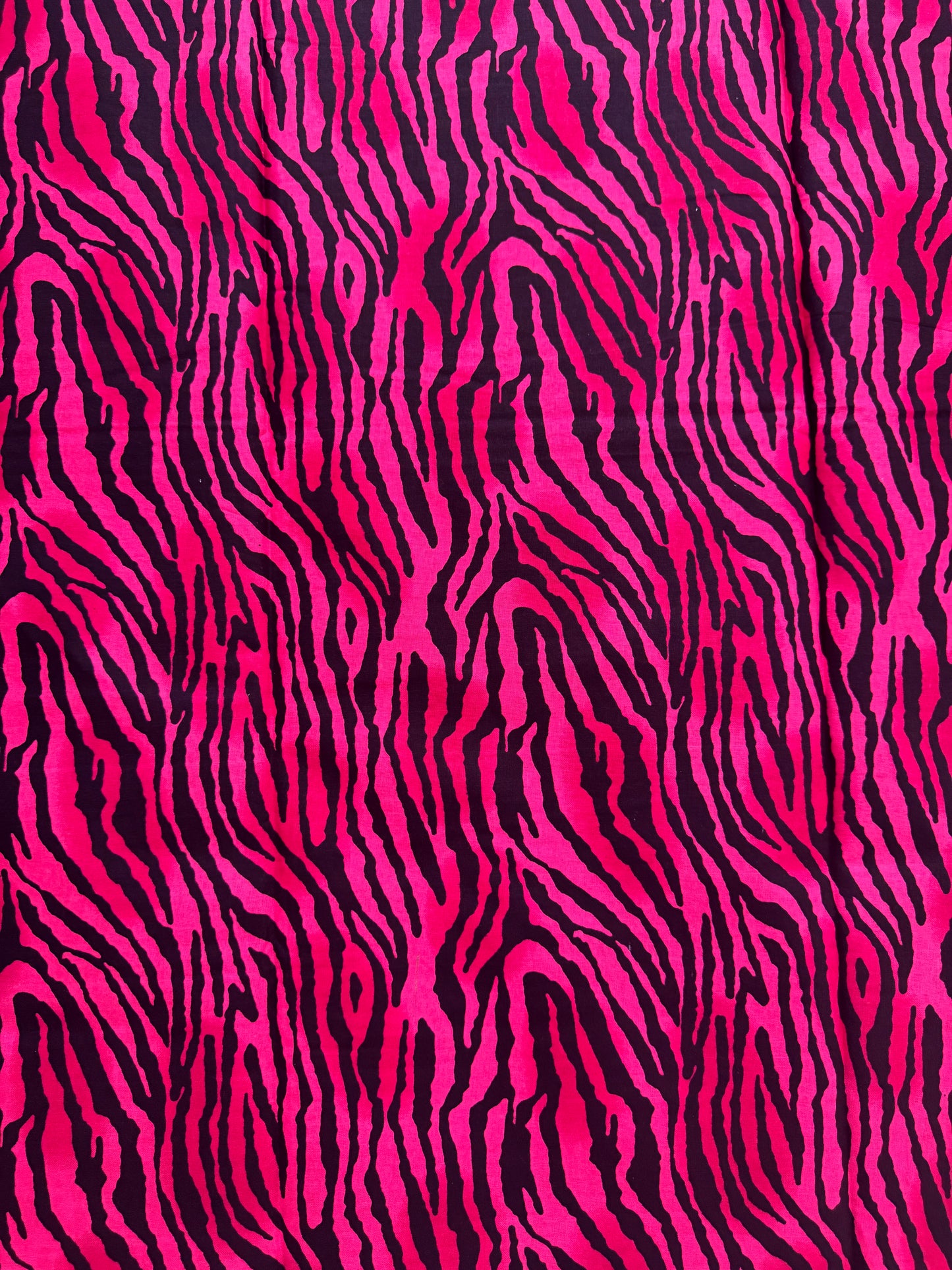 Zebra pattern with pink and black stripes on a fabric background