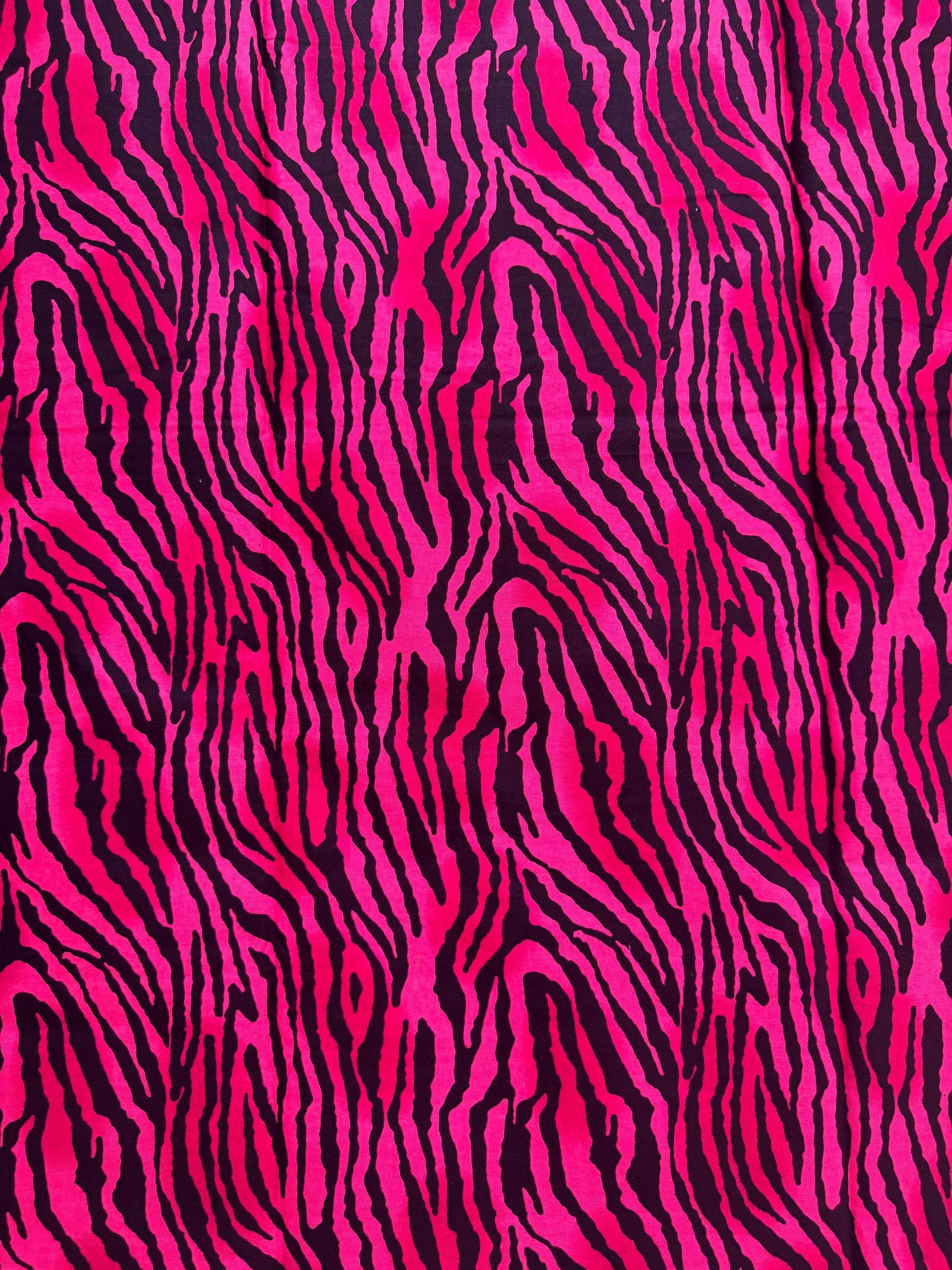 Zebra pattern with pink and black stripes on a fabric background