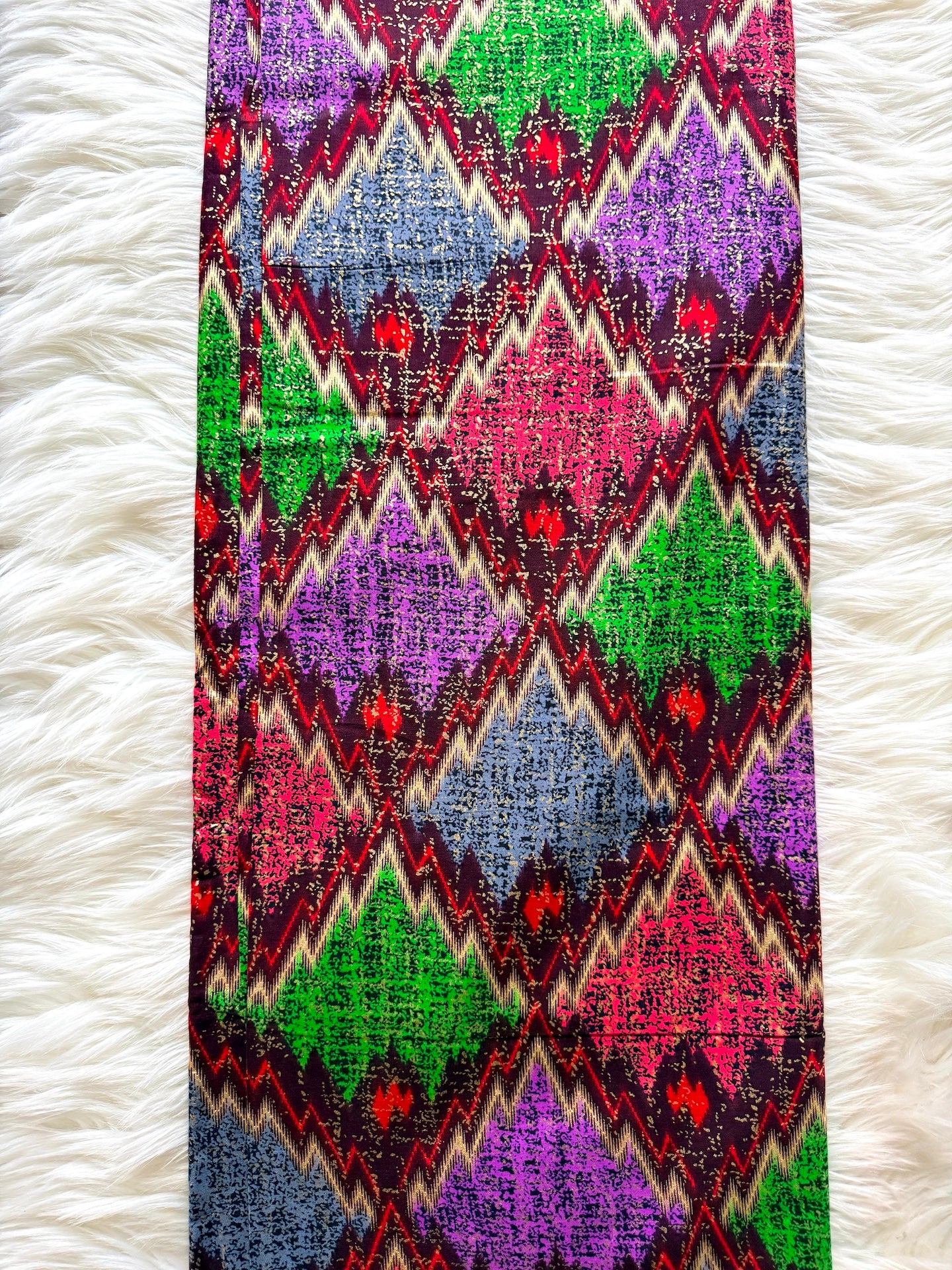 Colorful patterned fabric on a white textured surface
