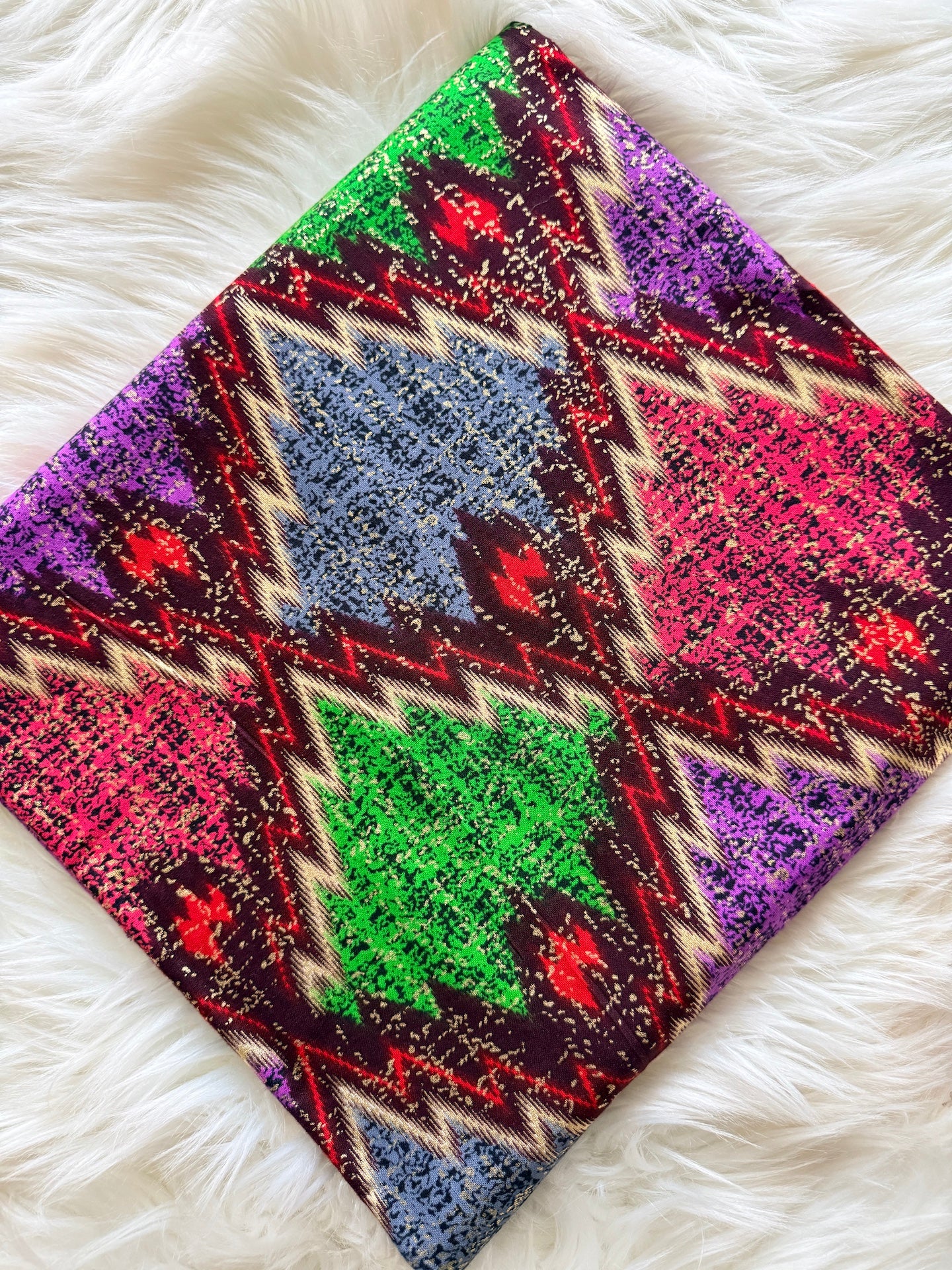 Colorful patterned fabric on a white fluffy surface