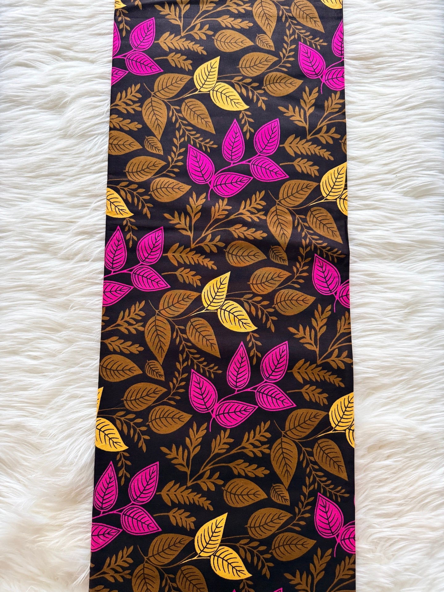 Tie with leaf pattern on a black background on a white textured surface