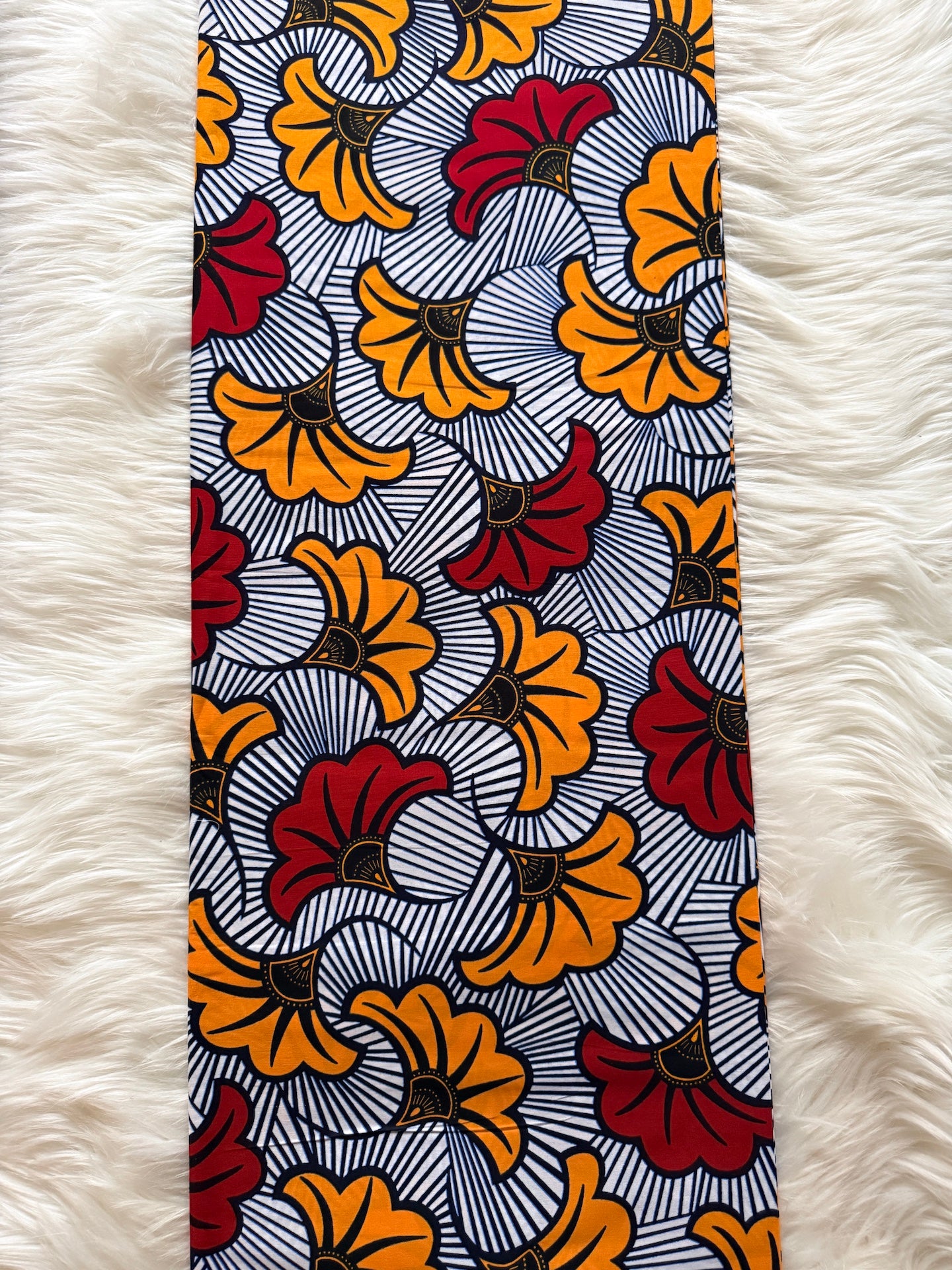 Tie with a colorful floral pattern on a white fur background