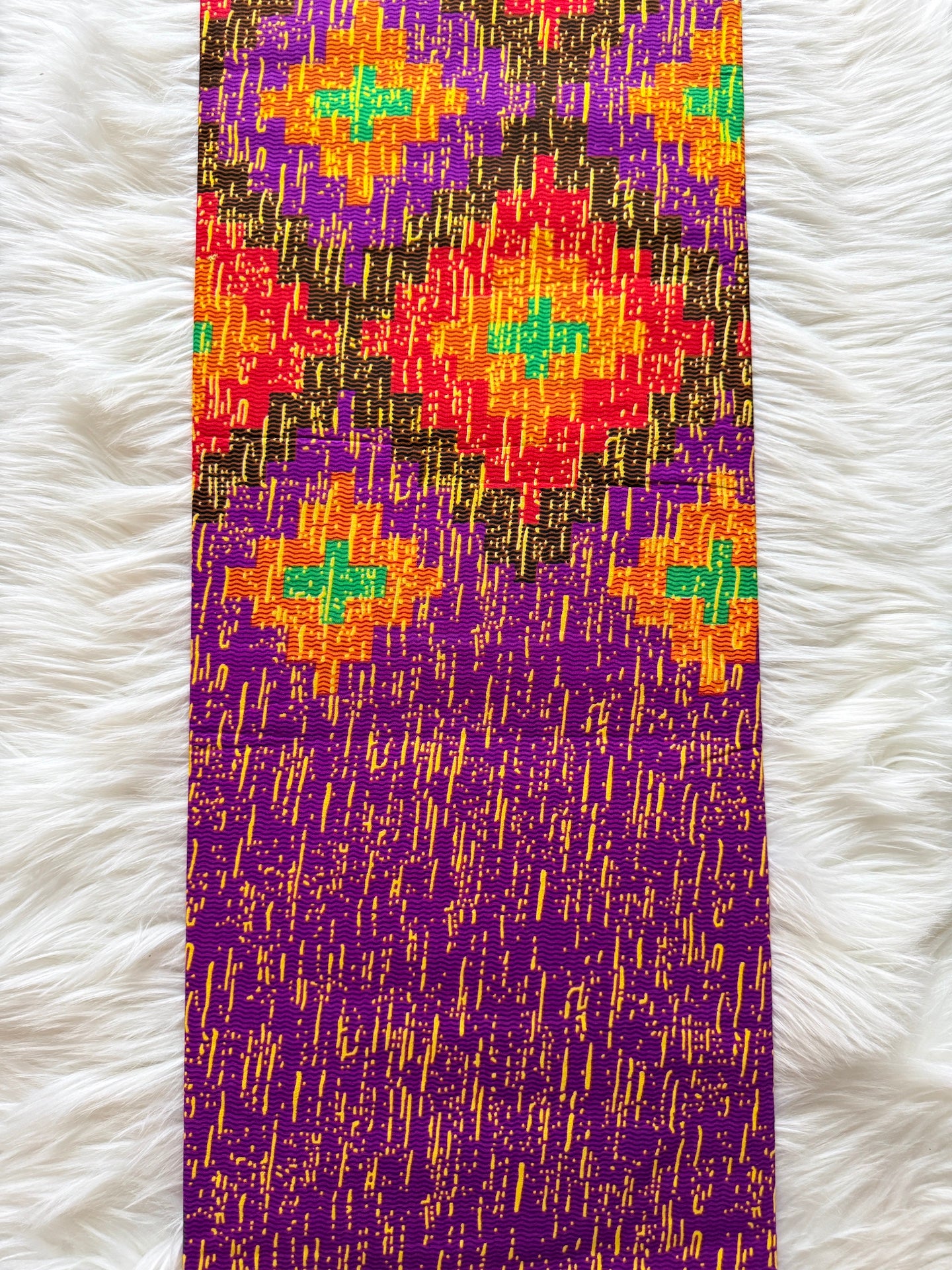 Colorful patterned fabric on a white fluffy surface