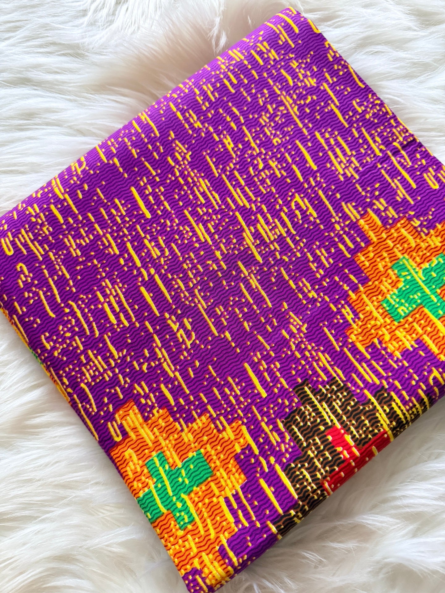 Colorful fabric with geometric pattern on a white fluffy surface