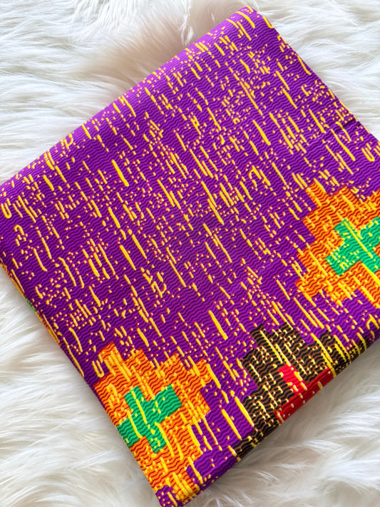 Colorful fabric with geometric pattern on a white fluffy surface